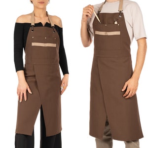 May include: Two brown aprons with a tan pocket and adjustable straps. The aprons are made of a durable fabric and are ideal for protecting your clothes while you work.