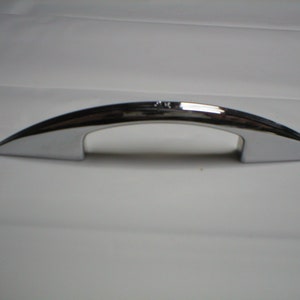 May include: A chrome-plated, arched handle with a pointed end. The handle is designed for pulling or lifting.