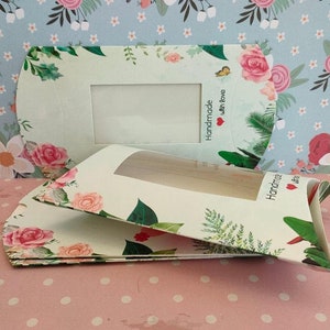 May include: Two white gift boxes with floral patterns and a window to see inside. The boxes have the text "Handmade with love" on them.