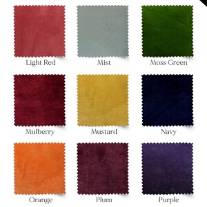 May include: Nine fabric swatches in various colors, including light red, mist, moss green, mulberry, mustard, navy, orange, plum, and purple. Each square has a scalloped edge and a label with the color name.