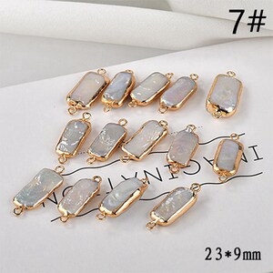 May include: Rectangular, iridescent pearl beads with gold-colored metal edging. Each bead has a loop at each end for stringing. The image includes the text "7#" and "23*9mm". These beads are suitable for jewelry making.