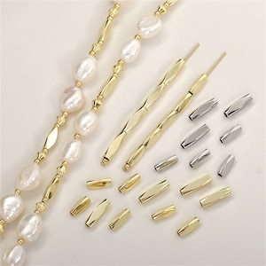 May include: A set of gold and silver crimp beads for jewellery making. The beads are arranged in a pattern on a white surface. There are two gold tools for crimping the beads.