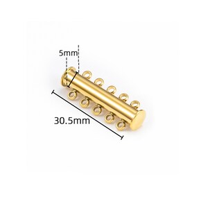 May include: A gold-colored cylindrical jewelry clasp featuring five small circular loops on one side. The component measures 30.5mm in length and 5mm in diameter, as indicated by the technical measurement lines and text visible in the image.