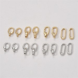 Könnte beinhalten: Ein Set mit 12 goldenen und silbernen Hummerverschlüssen. Die Verschlüsse sind oval geformt und haben einen federbelasteten Mechanismus. Sie sind perfekt für die Herstellung von Schmuck oder anderen Bastelarbeiten.