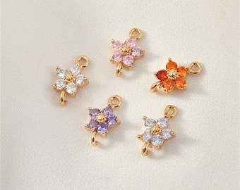 Puede incluir: Cinco abalorios de flores doradas con piedras de cristal de colores diferentes. Los abalorios tienen un bucle en la parte superior para sujetarlos a joyas.