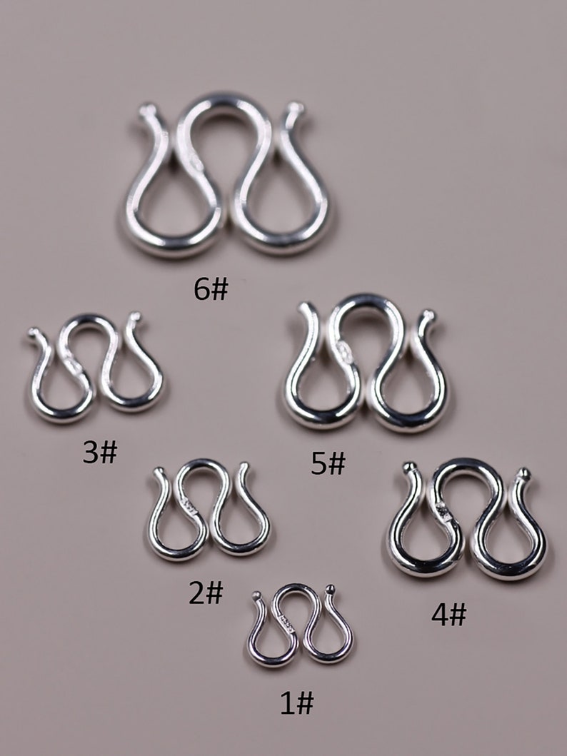 May include: Six silver jump rings of different sizes, labeled 1# through 6#. The rings are in the shape of a figure eight.
