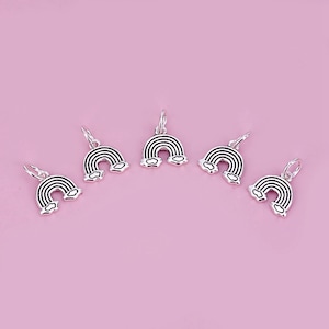May include: Five silver rainbow charms with a black outline and cloud details. The charms are on a pink background.