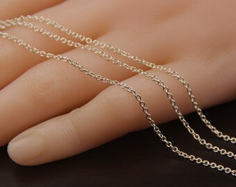May include: Three silver chains of varying lengths, laid out on a hand, showing the different sizes and styles.