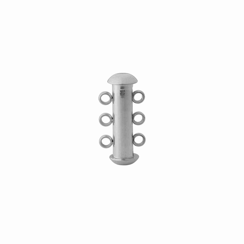 May include: A silver-toned cylindrical jewelry clasp featuring a smooth, polished finish. The component has a rounded cap at both the top and bottom ends, with three small, circular loops extending from each side for attaching jewelry strands.
