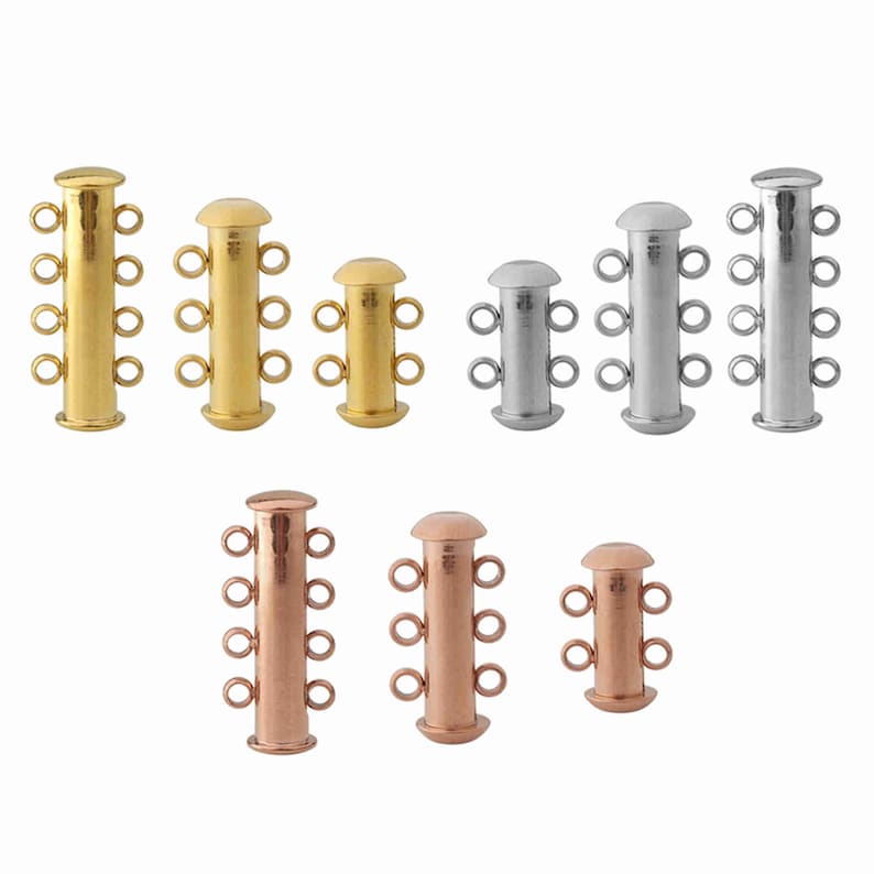 May include: A collection of cylindrical jewelry clasps in gold, silver, and rose gold tones. Each clasp features a smooth, rounded top and bottom with multiple small circular loops extending from the sides for attaching jewelry strands.
