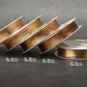 May include: Five spools of gold-colored wire, each with a different diameter, labeled 0.3mm, 0.4mm, 0.5mm, 0.6mm, and 0.8mm.