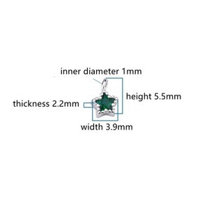 May include: A silver star charm with a green gemstone in the center. The charm is 5.5 mm high, 3.9 mm wide, and 2.2 mm thick. The inner diameter of the loop is 1 mm.