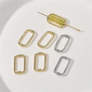 May include: A set of six gold and silver metal jump rings. The jump rings are oval shaped and have a smooth finish. They are perfect for jewelry making and crafting.