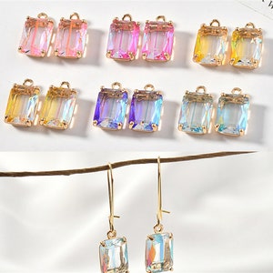 May include: Assortment of colorful iridescent glass earrings with gold-tone ear wires. The earrings are rectangular in shape and feature a variety of colors, including pink, yellow, blue, and purple.