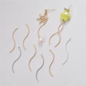 May include: A set of gold and silver chain connectors for jewelry making. The connectors are in the shape of a curved line. There are 8 connectors in total.