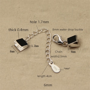 May include: Silver chain extender with a 8 mm water drop buckle and two 6 mm silver clasps. The chain is 4 cm long and 2.5 mm wide. The extender is marked "S925".