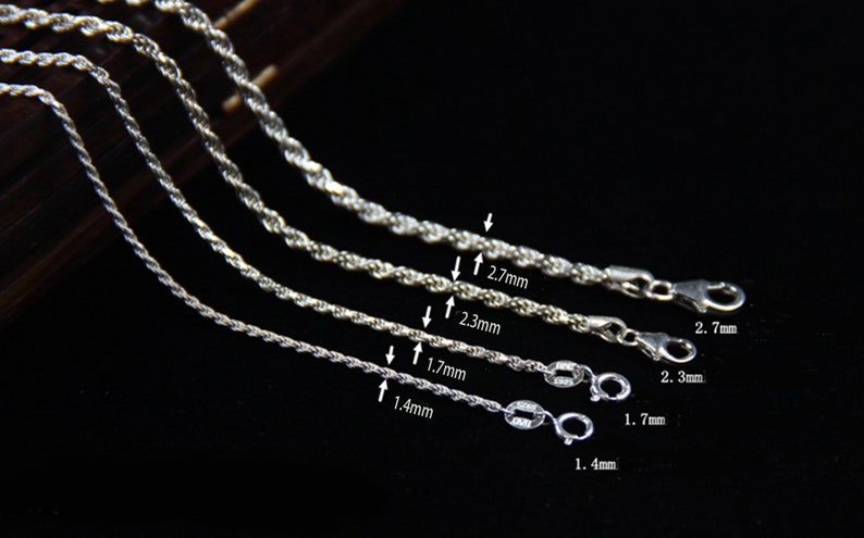 May include: Close-up of four silver rope chains of varying thicknesses. The chains range from 1.4mm to 2.7mm in diameter. Each chain has a lobster clasp. The image is on a dark background.