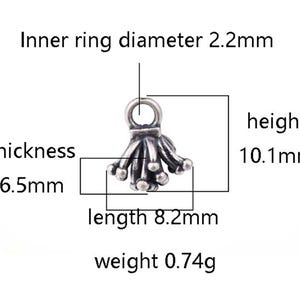 May include: Silver-toned metal charm with a tassel design. The charm measures 8.2 mm in length, 10.1 mm in height, and 6.5 mm in thickness. It weighs 0.74 grams.