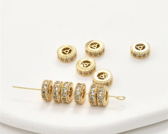 May include: Gold-toned metal beads with clear crystal accents. The beads are round and have a decorative design.