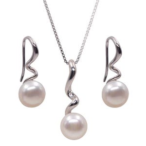 May include: A jewelry set featuring a silver-toned necklace and earrings. The necklace has a curved pendant with a small gemstone, and the earrings have a similar design. Each piece holds a large, round, white pearl. The set is displayed against a white background.