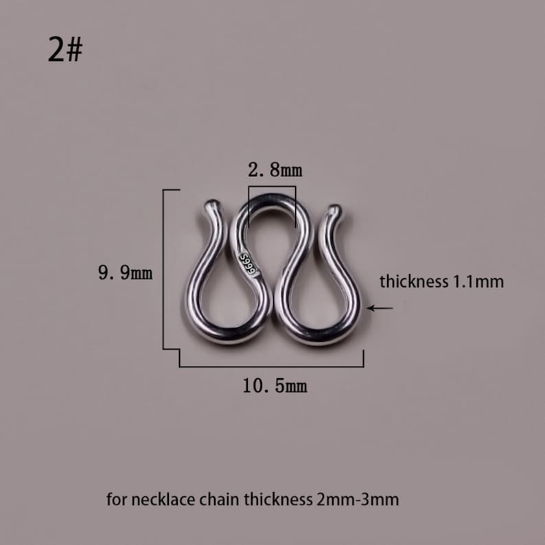 May include: Silver-toned metal connector for a necklace chain, measuring 2.8 inches in length, 0.99 inches in width, and 0.11 inches in thickness. The connector is marked with "S999" and is designed for necklace chains with a thickness of 2 to 3 millimeters.