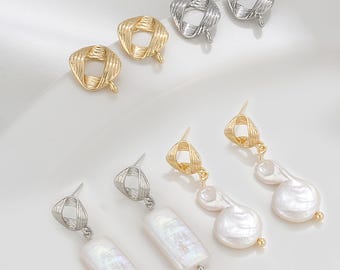 May include: An assortment of earrings in gold and silver tones. Some earrings feature a woven square design, while others have rectangular or teardrop-shaped white pearls. The earrings are displayed on a white surface.