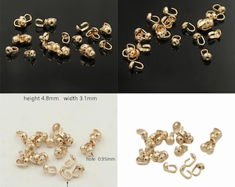 May include: A selection of small, gold-coloured jewellery findings, including crimp beads and open jump rings. The crimp beads are approximately 4.8mm in height and 3.1mm in width. The hole is 0.95mm, and the thickness is 1.2mm.