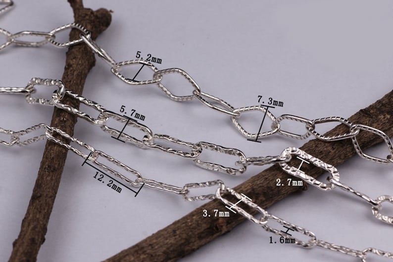 Pode incluir: Quatro correntes de prata com elos de tamanhos diferentes. Os elos s&atilde;o texturizados e t&ecirc;m uma forma retangular. As correntes s&atilde;o medidas em mil&iacute;metros: 5,2 mm, 5,7 mm, 7,3 mm e 12,2 mm.