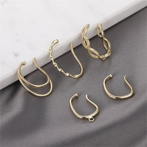 May include: Set of six gold-toned ear cuffs in various styles, including a twisted design, a double-loop design, and a simple curved design.