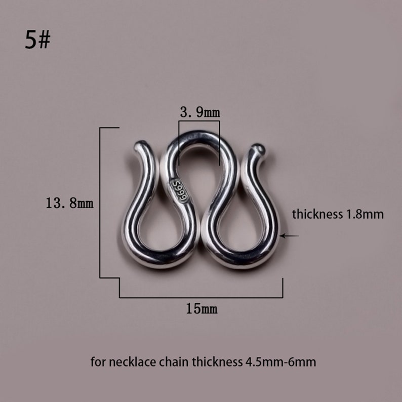 May include: Silver S-shaped clasp for necklaces, measuring 1.8 mm thick, 15 mm wide, and 13.8 mm tall. The clasp is marked with "S999" and is designed for necklace chains between 4.5 mm and 6 mm thick.