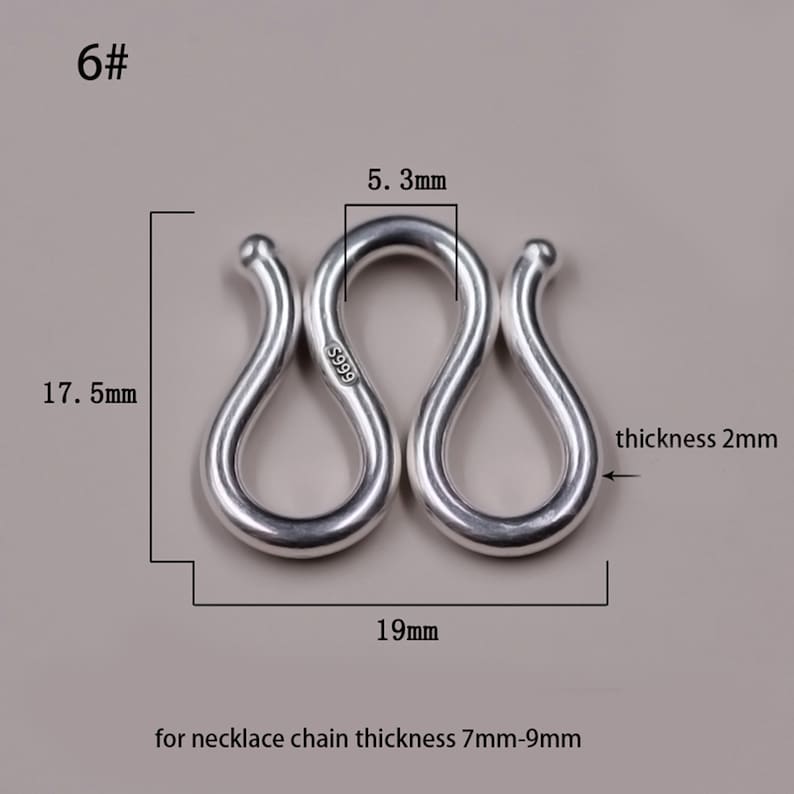 May include: Silver S-shaped clasp for necklaces, measuring 19 mm wide, 17.5 mm tall, and 5.3 mm thick. The clasp is marked "S999" and is designed for necklace chains with a thickness of 7 mm to 9 mm.