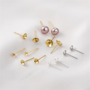 May include: Assortment of gold and silver earring posts with pearl cup settings. The earring posts are ideal for making your own earrings.