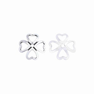 May include: Two silver-toned metal flower-shaped bead caps with a hole in the center. The caps are made of four heart-shaped loops.