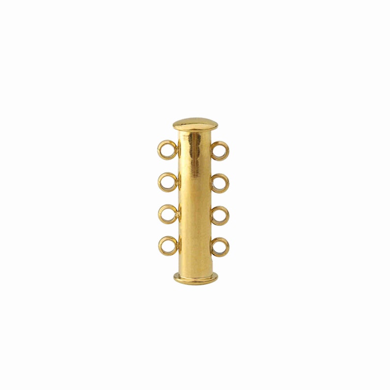 May include: A gold-toned cylindrical jewelry clasp featuring four small circular loops on each side, totaling eight connection points. The clasp has a smooth, polished finish with a flat cap at the top and a slightly wider base at the bottom.