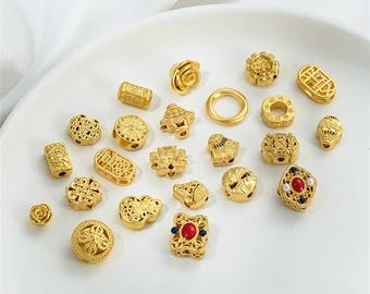 May include: A collection of 20 gold-tone metal charms with various designs, including flowers, geometric shapes, and Chinese characters. The charms are perfect for adding a touch of elegance to jewelry projects.