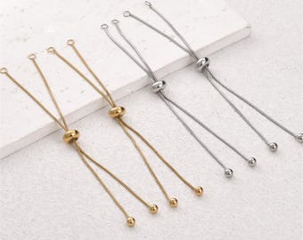 May include: Two gold-toned and two silver-toned adjustable bracelet chains. Each chain features a thin snake-style cord, a sliding bead mechanism for size adjustment, and small spherical end caps on the dangling loose ends of the metal cords.
