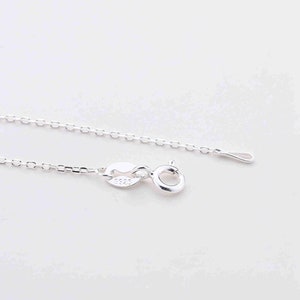 May include: A silver chain necklace with a lobster clasp and a small tag that says "925".