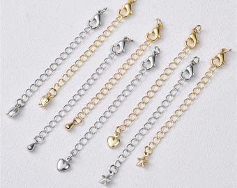 May include: Six gold and silver extender chains with different charms, including a heart, star, and flower. The chains are approximately 2 inches long.