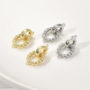 May include: Two pairs of gold and silver twisted metal jewelry findings with a ring and a loop. The findings are perfect for adding to necklaces, bracelets, or earrings.