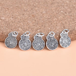 May include: Five silver charms with Chinese characters for the five elements: Metal, Wood, Water, Fire, and Earth. Each charm is circular and features a detailed design.