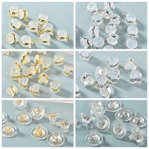 May include: Assortment of clear plastic earring backs in various shapes, including round, heart, and post styles. Some backs have a gold or silver metal rim.