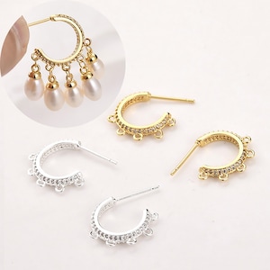 May include: Gold and silver-toned hoop earring components featuring a row of small clear stones and five loops for attaching charms. One gold hoop is shown with five dangling white teardrop-shaped pearls attached to the loops.