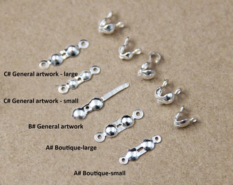 May include: Assortment of silver-toned metal clasps for jewelry making. The clasps are in various shapes and sizes, including small and large.
