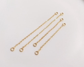 May include: Four gold extender chains with jump rings at each end. The chains are approximately 2 inches long.
