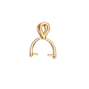 May include: A gold-colored pendant bail with a loop at the top and a curved, open base with two small posts. The bail is designed to attach to a necklace or chain, and is set against a white background.