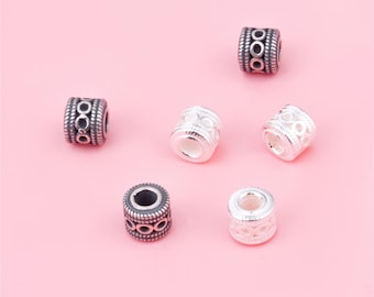 May include: Six silver spacer beads with intricate designs. The beads are round and have a textured surface. Some beads are silver with a black finish.