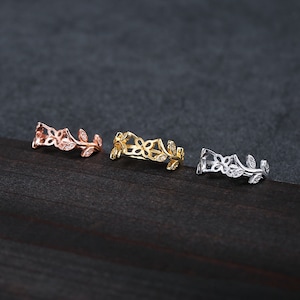 May include: Three delicate rings with a floral design. The rings are made of metal and have a gold, rose gold, and silver finish.