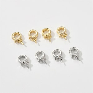May include: A set of ten gold and silver metal bead caps with a loop and a pin. The bead caps are designed to be used with jewelry making.