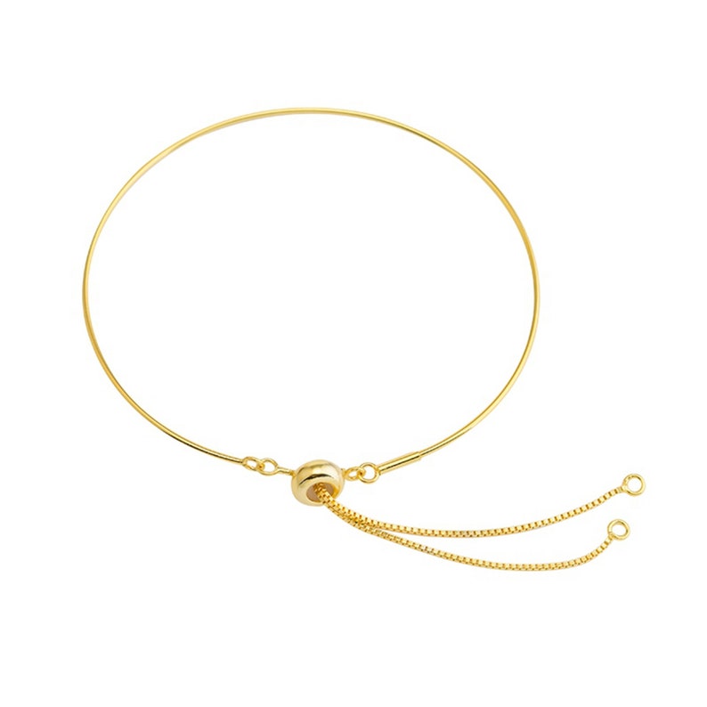 May include: A gold adjustable bracelet with a sliding bead and two chain ends.