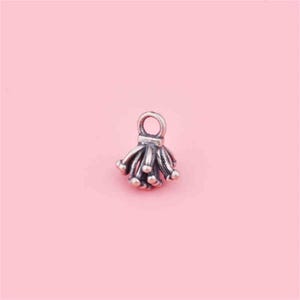 May include: Silver charm with a delicate, intricate design resembling a cluster of small flowers or a firework burst.